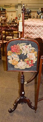 Lot 1210 - A Victorian painted glass firescreen together with a needlework pole screen of similar date and...