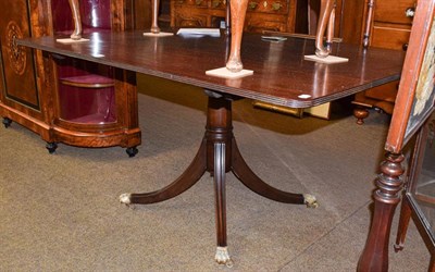 Lot 1211 - A Regency mahogany snap-top breakfast table raised on reeded sabre supports with brass claw...