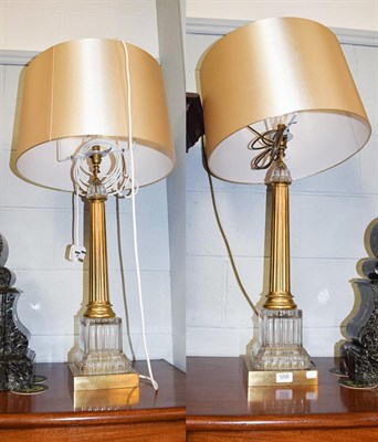 Lot 1230 - A large pair of glass and brass fluted column form table lamps, 65cm to the fitting
