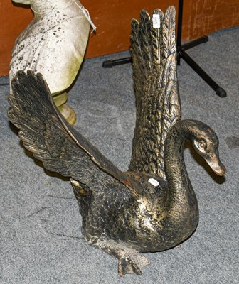 Lot 1249 - A cast bronzed metal sculpture of a swan with outstretched wings, 67cm high