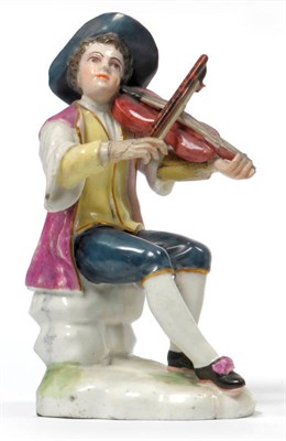 Lot 149 - A German Porcelain Figure of a Violinist, possibly Thuringian, circa 1780, sitting on a rocky mound
