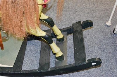 Lot 1264 - A painted dappled rocking horse on fixed base, 138cm long by 96cm high to the tip of the ears. This