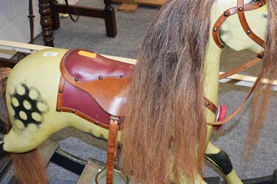 Lot 1264 - A painted dappled rocking horse on fixed base, 138cm long by 96cm high to the tip of the ears. This