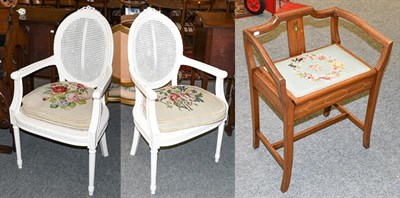 Lot 1274 - A pair of painted French fauteuil, with cane work panels, and needle work cushions together with an