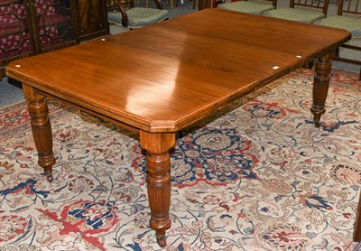 Lot 1287 - A Victorian walnut wind-out dining table with additional leaf, with canted corners, raised on...
