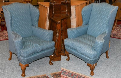 Lot 1296 - A pair of Queen style walnut framed wing back armchairs, raised upon shell carved cabriole supports