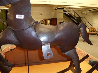 Lot 1299 - A decorative metal rocking horse, 90cm long by 72cm high to the tip of the ears