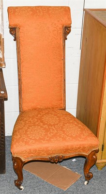 Lot 1309 - A Victorian carved walnut prie-dieu chair upholstered in gold and copper fabric, 106cm high