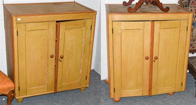 Lot 1310 - A pair of stained pine two-door side cabinet, 94cm by 68cm by 105cm (2)