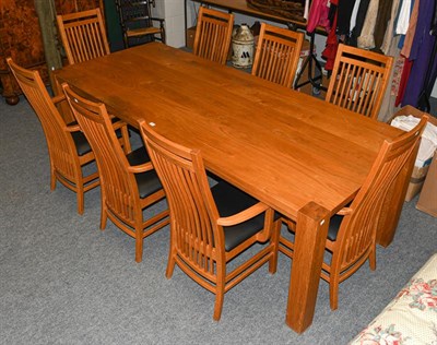Lot 1312 - A modern oak plank top dining table, with square supports, together with a set of eight...
