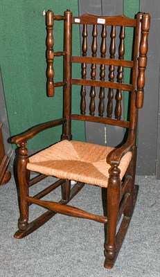 Lot 1315 - A 19th century ash and elm spindle back rocking chair with rush seat