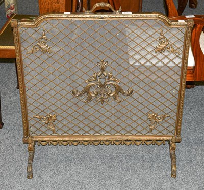 Lot 1321 - A 20th century brass spark guard, with mesh panel adorned with scrolls, 73cm by 78cm