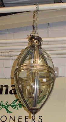 Lot 1337 - A large hanging lantern, modern, of oval form, with glass panels and chromed finish, 80cm approx