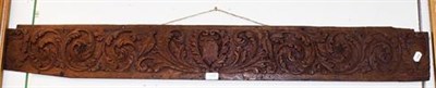 Lot 1338 - A 17th / 18th century carved oak panel decorated with exotic bird among foliage, 134cm