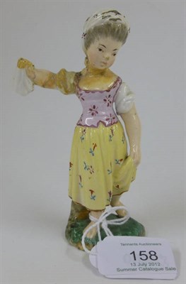 Lot 158 - A Höchst, Damm Faience Figure of a Girl, 19th century, holding a bag in her raised right arm,...