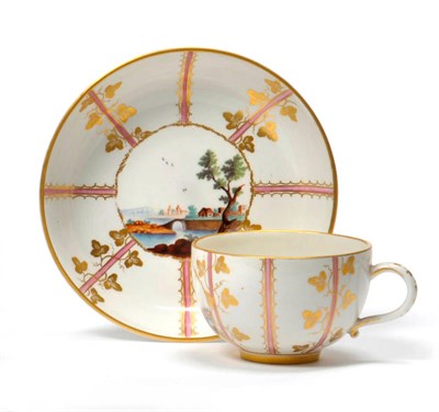 Lot 174 - A Höchst Porcelain Teacup and Saucer, circa 1775, painted in colours with a river landscape within