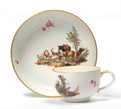 Lot 176 - A Höchst Porcelain Teacup and Saucer, circa 1765, each painted with a vignette of goats in...