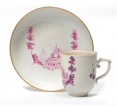 Lot 177 - A Wallendorf Porcelain Coffee Cup and Saucer, circa 1775, painted in monochrome puce with buildings