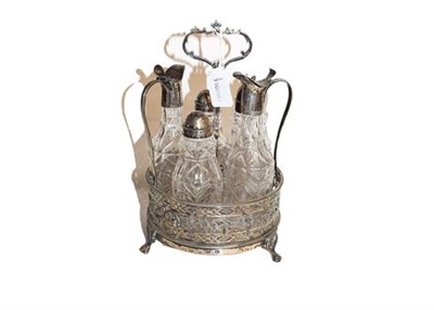 Lot 194 - ~A George III silver six bottle cruet stand and associated bottles (unmarked) by Thomas Daniel,...