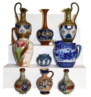 Lot 247 - ~ Doulton pottery comprising a pair of Royal Doulton ewers (a.f.), a Doulton Lambeth vase and...
