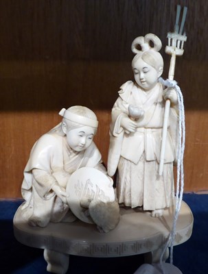 Lot 284 - A 19th century Japanese Ivory Okimono, depicting a man and a lady collecting a turtle, 13.5cm high