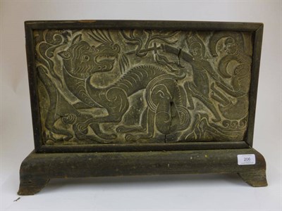 Lot 206 - A Chinese Grey Pottery Architectural Tile, in Archaic style, carved with sinuous dragon being...
