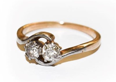 Lot 316 - A diamond two stone twist ring, finger size M