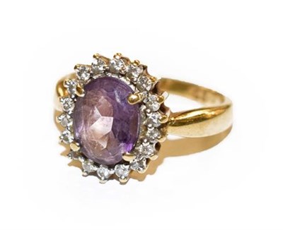 Lot 319 - An 18 carat gold amethyst and diamond cluster ring, finger size L1/2