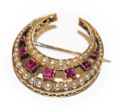 Lot 328 - An Edwardian synthetic ruby and split pearl crescent brooch, seven graduated round cut...