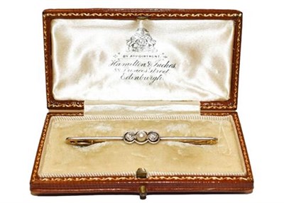 Lot 333 - A cultured pearl and diamond bar brooch, length 5.3cm, in a fitted case