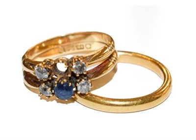 Lot 339 - A 22 carat gold band ring, finger size R; and an 18 carat gold synthetic sapphire and diamond ring