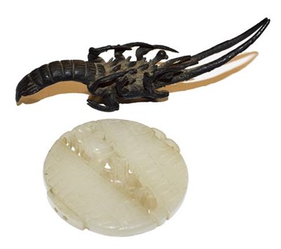 Lot 349 - A Chinese carved pale celadon jade roundel together with a Japanese bronze stylized shellfish (2)