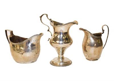 Lot 360 - ~A George III cream jug of helmet form, London 1807, makers mark indistinct, a George III...