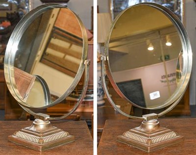 Lot 383 - A pair of vintage brass Durlston design vanity mirrors, both with applied labels to the mirror...