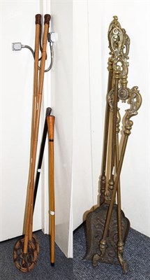 Lot 398 - Two walking canes, a pair of bamboo ski poles, and a four piece brass companion set (8)