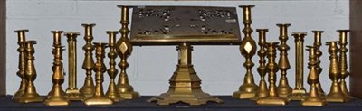 Lot 405 - ~A Victorian ecclesiastical brass book stand, pierced and engraved with four saints on a...