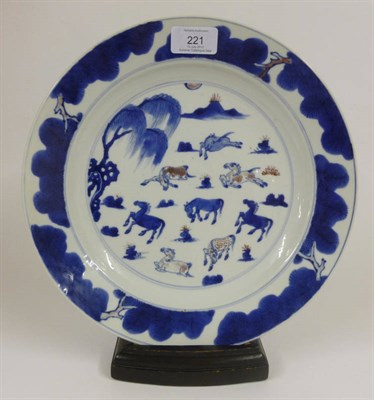 Lot 221 - A Chinese Porcelain Plate, 18th century, painted in underglaze red and blue with the Eight...