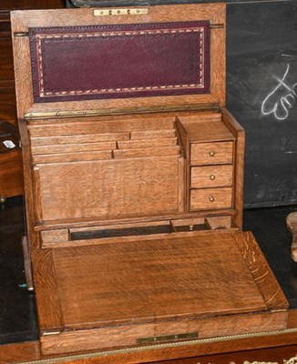 Lot 477 - An early 20th century oak desk top correspondence box, with four-front writing slope