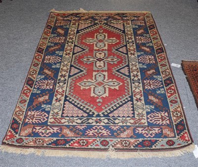 Lot 1086 - An Afghan Baluch rug the field with columns of barber poles beneath the Mihrab enclosed by...