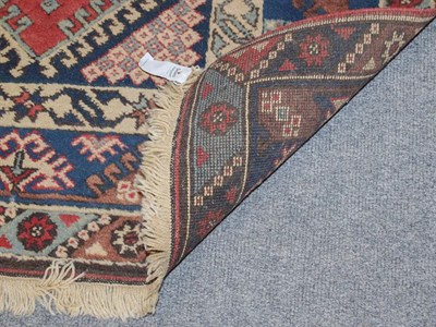 Lot 1086 - An Afghan Baluch rug the field with columns of barber poles beneath the Mihrab enclosed by...