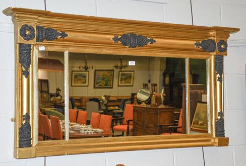 Lot 1110 - A Regency sectional break-front over-mantle mirror with black painted embellishment on a gilt...