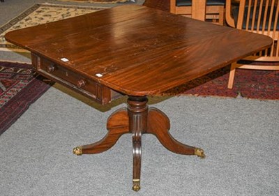 Lot 1114 - Regency mahogany centre-pedestal Pembroke table with single drawer and brass lion claw castors...