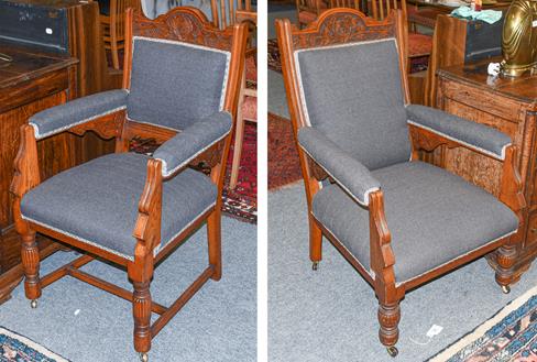 Lot 1115 - A pair of Victorian ladies and gents carved oak fireside armchairs, with grey upholstery and raised