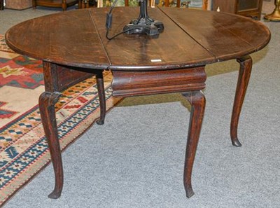 Lot 1117 - An 18th century oak drop leaf table, 125m by 110cm by 70cm