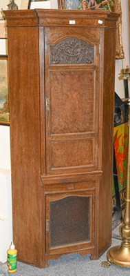 Lot 1122 - An early 20th century panelled oak floor standing corner cupboard, 85cm by 62cm by 183cm