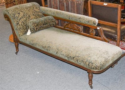 Lot 1138 - A late Victorian carved mahogany chaise-longue, with turned supports, 173cm by 64cm by 73cm