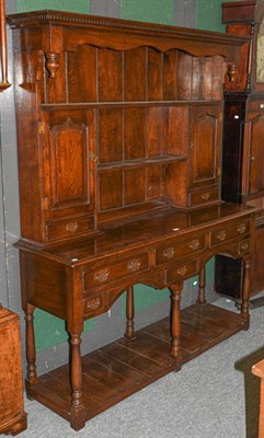 Lot 1157 - ~ A reproduction oak dresser and rack in the 17th century style, 152cm by 46cm by 188cm