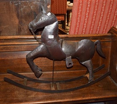 Lot 1176 - A decorative metal rocking horse, 90cm long by 72cm high to the tip of the ears