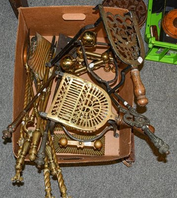 Lot 1199 - Three sets of brass fire irons, two pairs of andirons, two brass and steel clip on trivets, and...