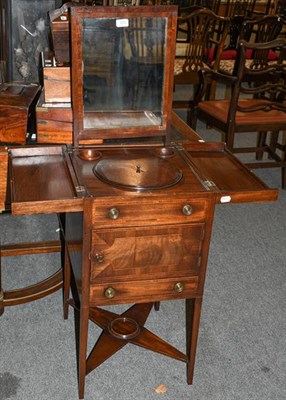 Lot 1272 - A George III mahogany wash stand the top opening to reveal a fitted interior with a lift out mirror